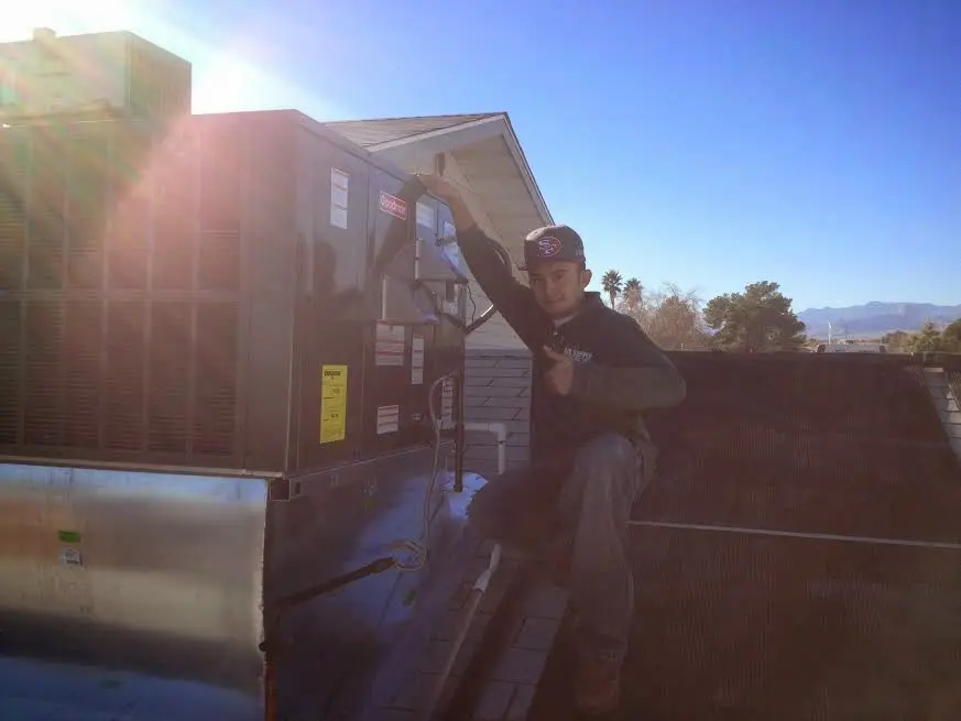 HVAC technician performing HVAC Inspection on a rooftop unit in Hillside